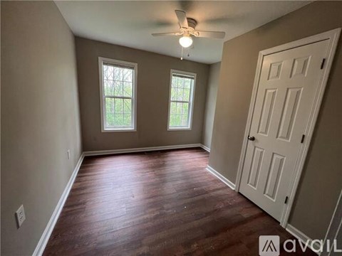 A room with wooden floors and a white door.