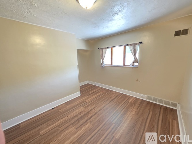 A bedroom with a bed, a window, and a closet.
