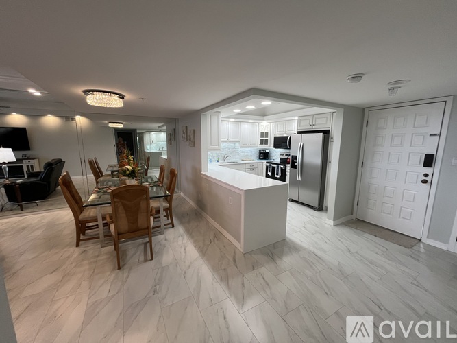 A modern kitchen with a dining table and chairs.
