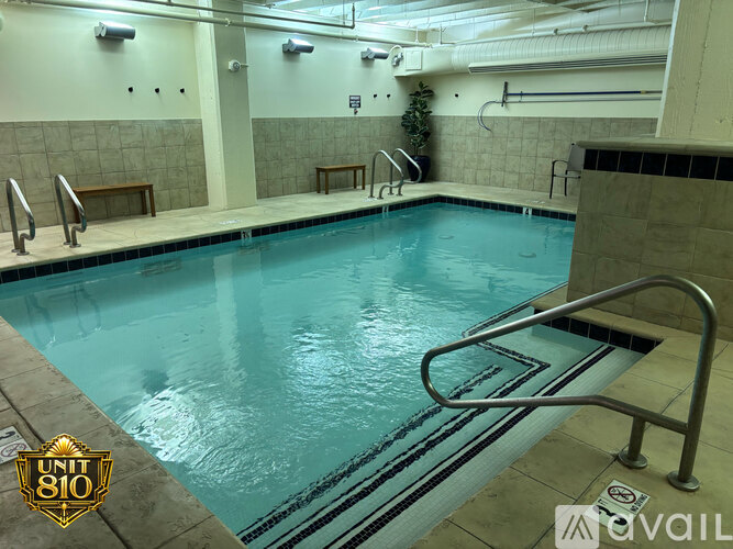 A swimming pool with a diving board and a logo that says UNIT 810.