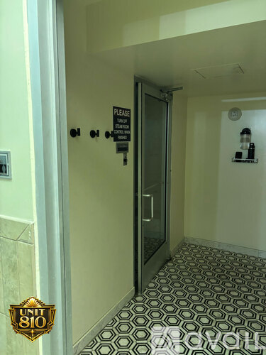A hallway with a sign that says "Please do not enter" and a door with a sign that says "No Trespassing".