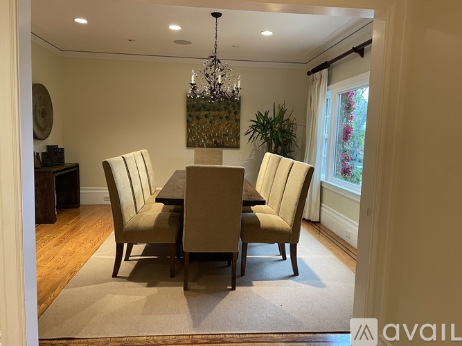 A dining room with a table and chairs.