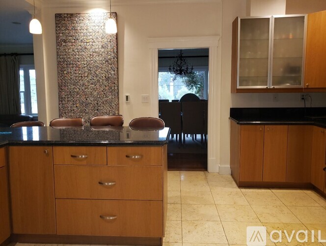 A kitchen with wooden cabinets and a black countertop.