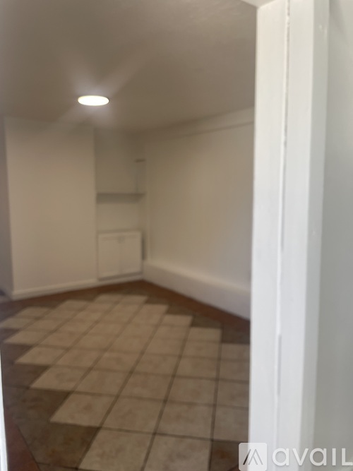 A room with a tiled floor and white walls.