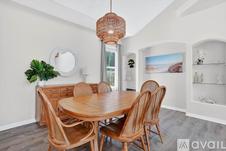 A dining room with a wooden table and chairs.