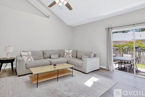 A living room with a grey sofa and a wooden coffee table.