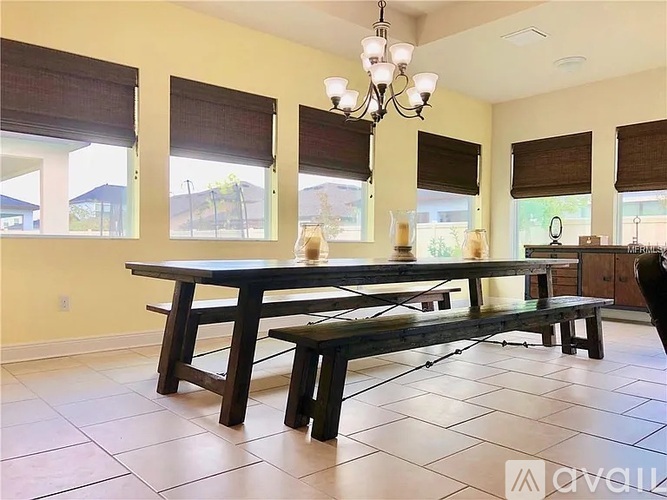 A dining room with a wooden table and benches.