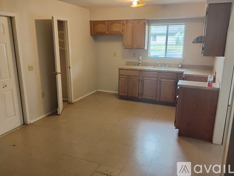 A kitchen with brown cabinets and a white fridge.