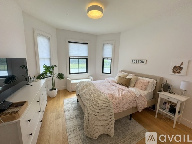 A bedroom with a bed, desk, and chair.