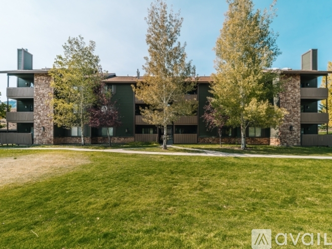 A modern building with a green lawn in front.