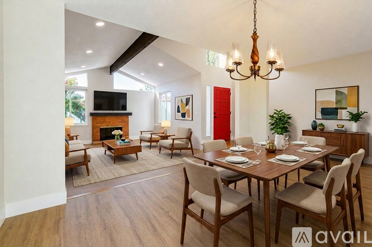 A dining room with a wooden table and chairs.