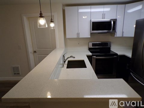 A kitchen with a sink and a microwave above it.