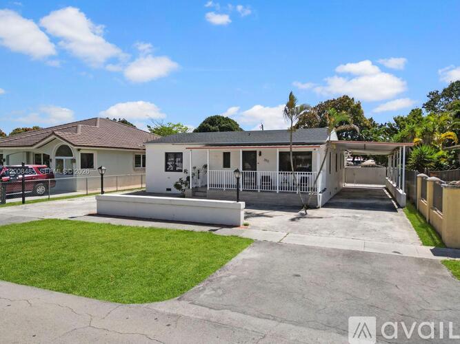A house with a driveway and a car parked in front.