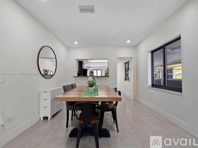 A dining room with a wooden table and chairs.