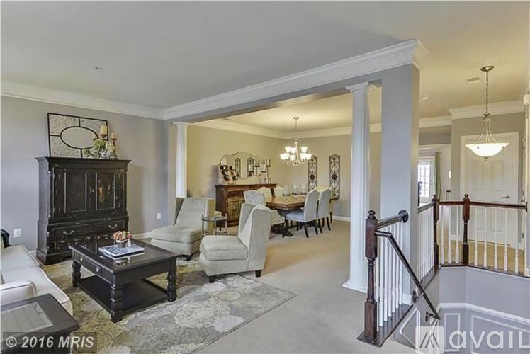 A living room with a black coffee table and a chandelier.