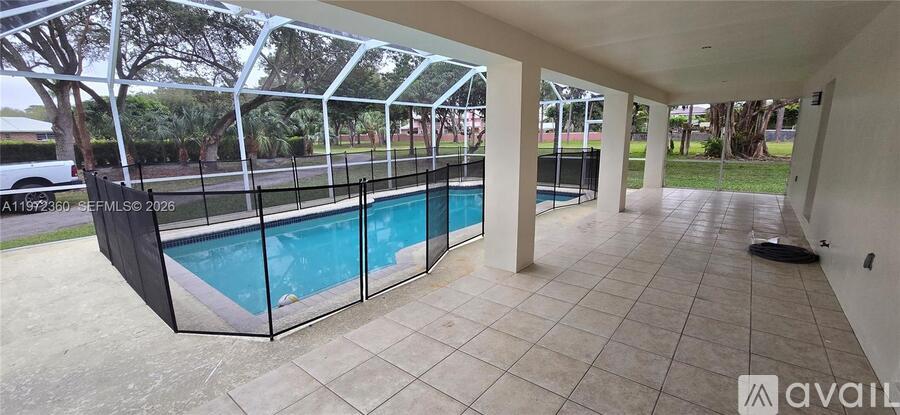 A large indoor pool with a glass wall surrounding it.