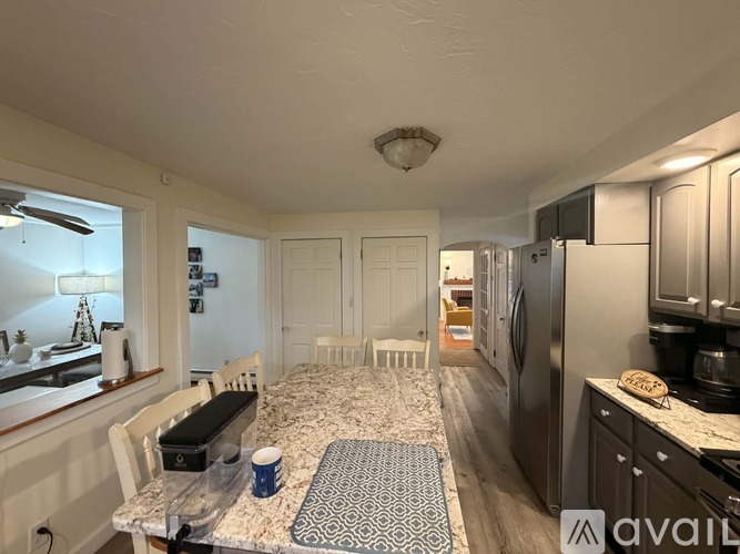 A kitchen with a table and chairs in the middle of the room.