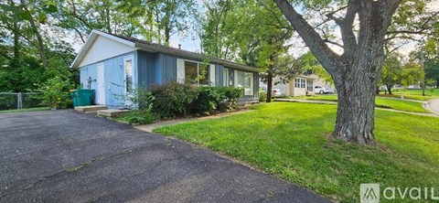 A blue house with a white roof is available for rent.