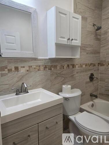 A bathroom with a sink, toilet and a tub.