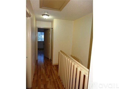 A long hallway with a white radiator on the wall.