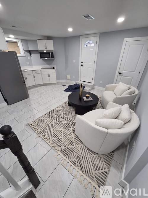 A kitchen with a refrigerator, microwave, and cabinets.