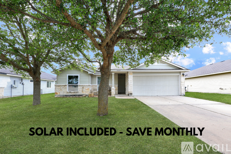 A house with a tree in front and the text "SOLAR INCLUDED - SAVE MONTHLY" overlaid on the image.