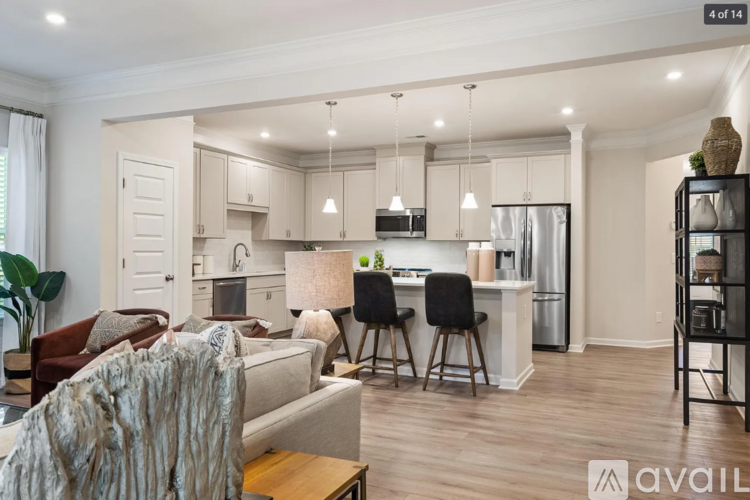 A modern kitchen with a dining area and a living room.