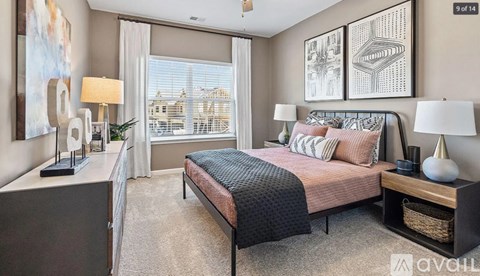 A bedroom with a large bed and a view of a cityscape through the window.