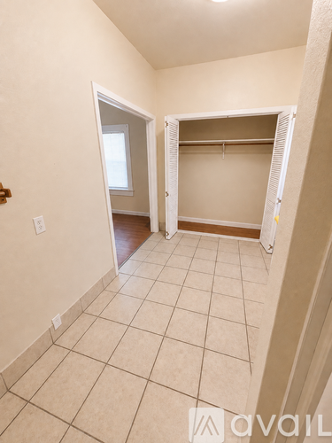 A spacious room with a tiled floor and a walk-in closet.