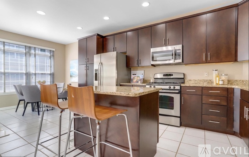 A kitchen with brown cabinets and a white island.