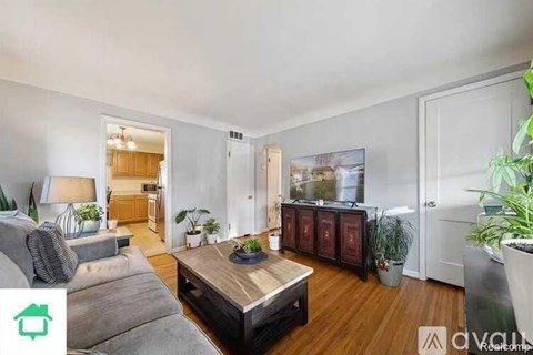 A living room with a grey couch and a wooden coffee table.