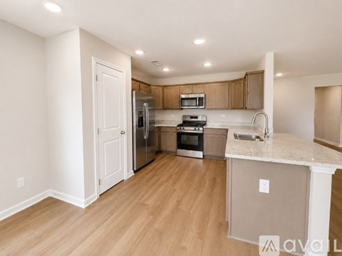 A kitchen with wooden floors and white walls.