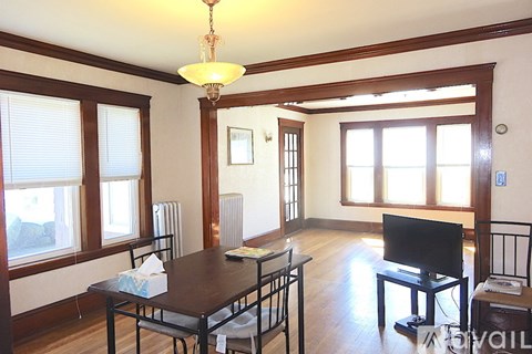 A living room with a brown table and chairs.