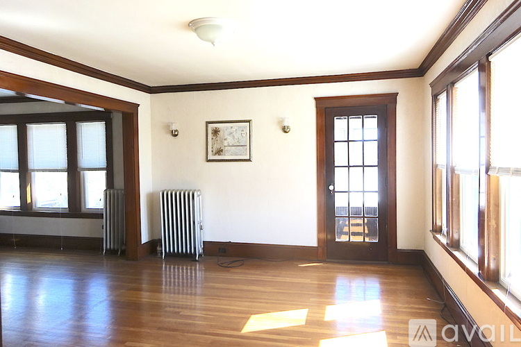 A room with a wooden floor and a window.