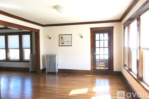 A room with a wooden floor and a window.