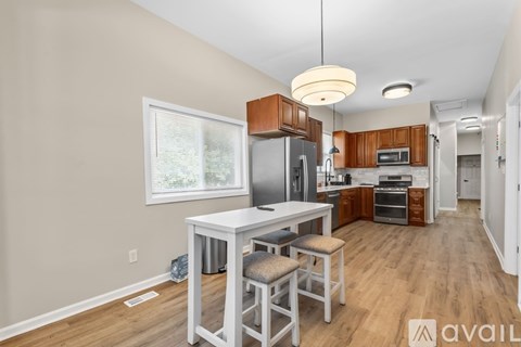 A kitchen with a table and chairs in the middle of the room.