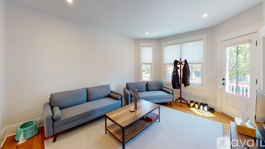 A living room with a grey couch and a coffee table.