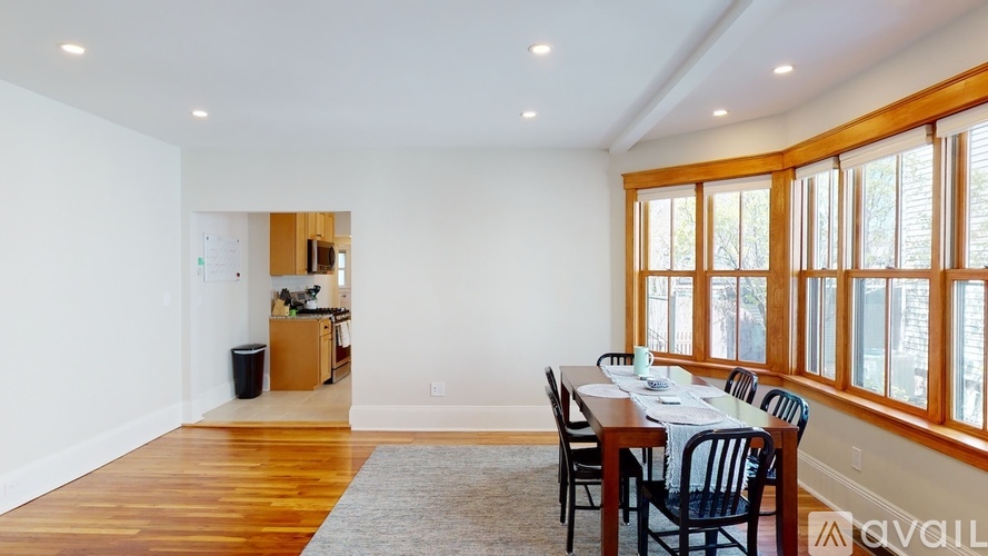 A dining room with a table set for six with a view of the outdoors.