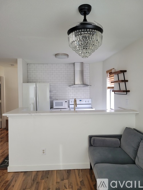 A kitchen with a white fridge and a white counter top.