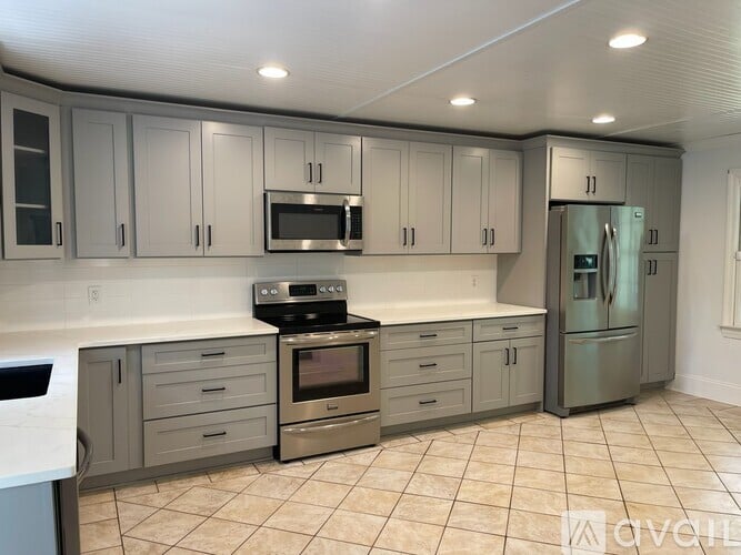 A kitchen with a stove, oven, and refrigerator.