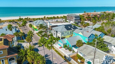 A beachfront community with houses and palm trees.
