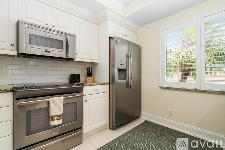 A kitchen with a stainless steel refrigerator and oven.