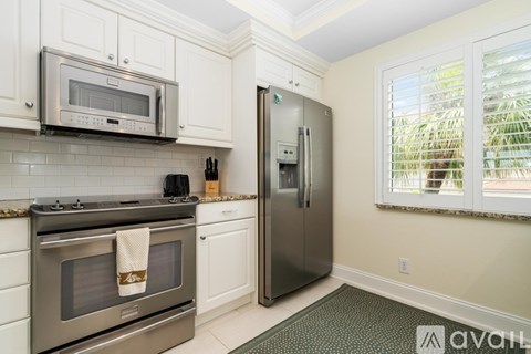 A kitchen with a stainless steel refrigerator and oven.