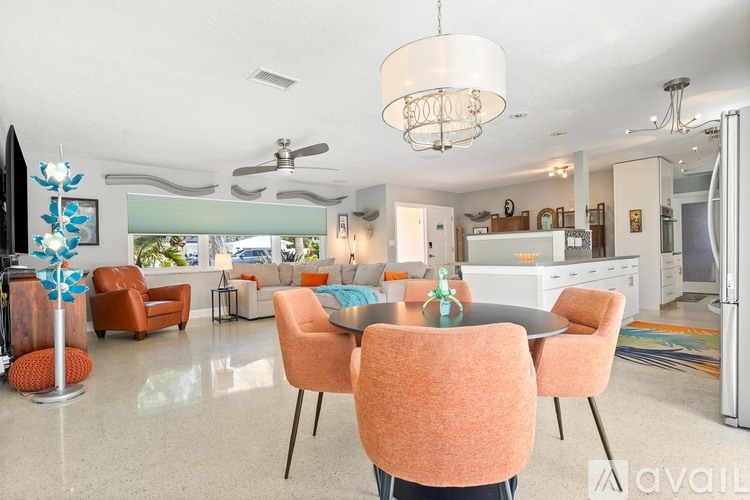 A modern dining room with a round table and chairs.