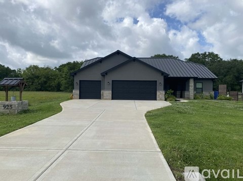 A two-story house with a garage and a driveway.