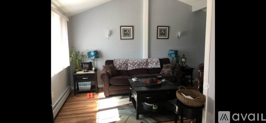 A living room with a couch, chair, and table.