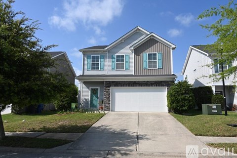A two-story house with a garage is for sale.