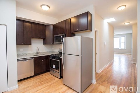 A kitchen with wooden cabinets and stainless steel appliances.
