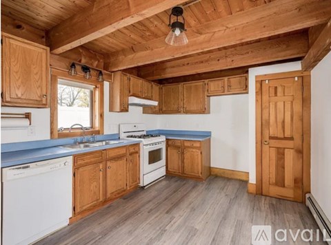 A kitchen with wooden cabinets and a blue countertop.