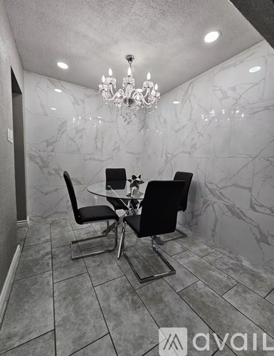 A dining room with a table and chairs.